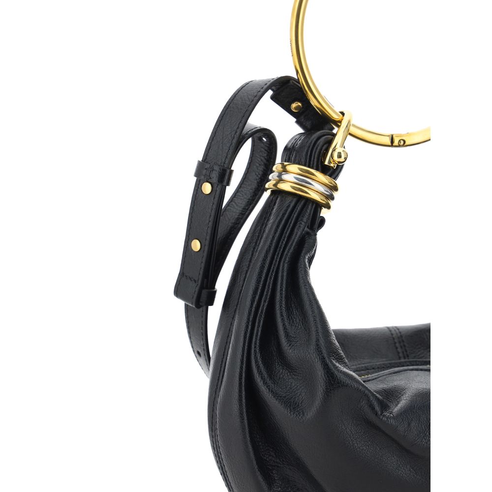 Model carrying black calf leather bracelet handle handbag by KILAUE
