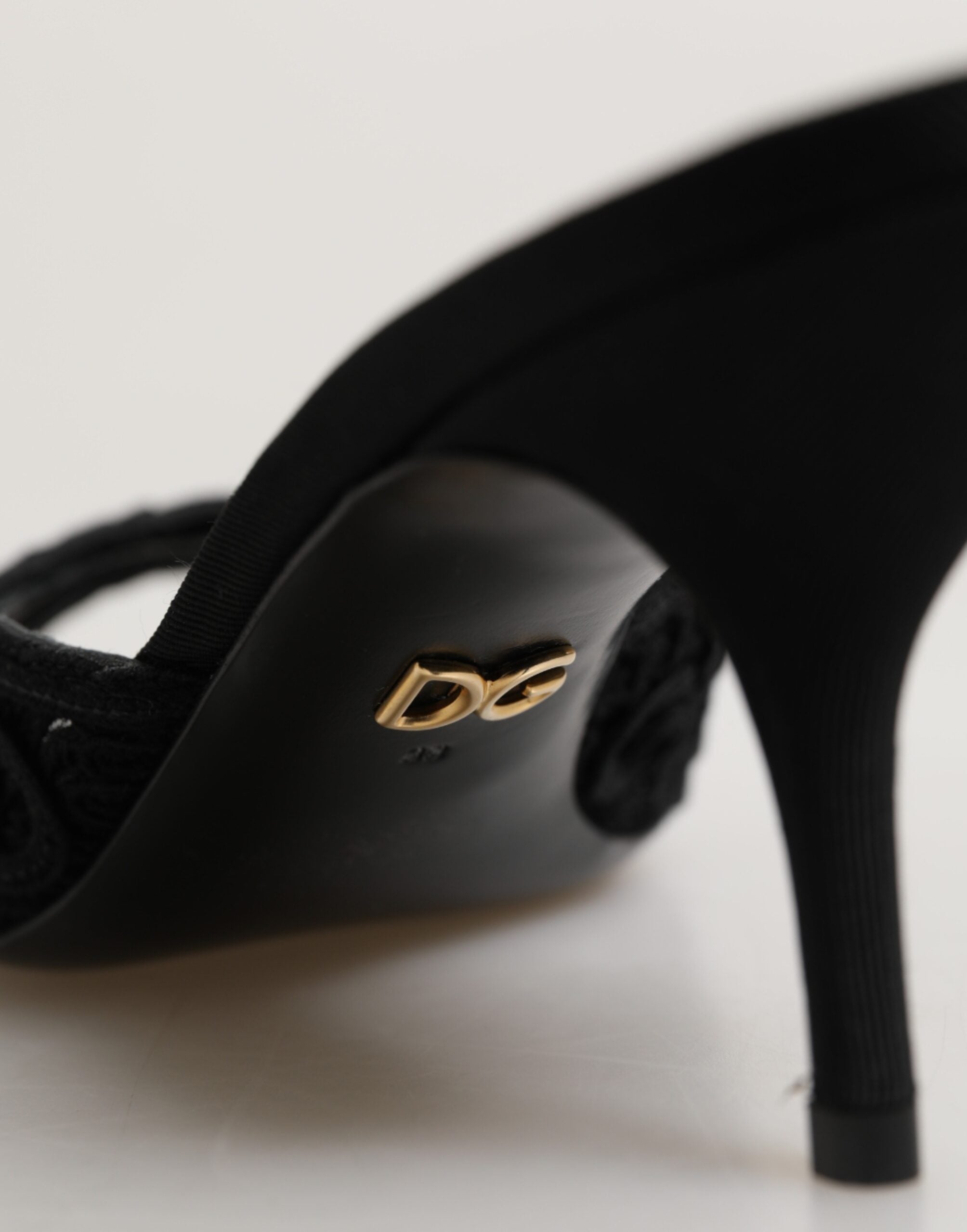 Close‑up embroidery detail of Dolce & Gabbana black embroidered slip‑on heels by KILAUE
