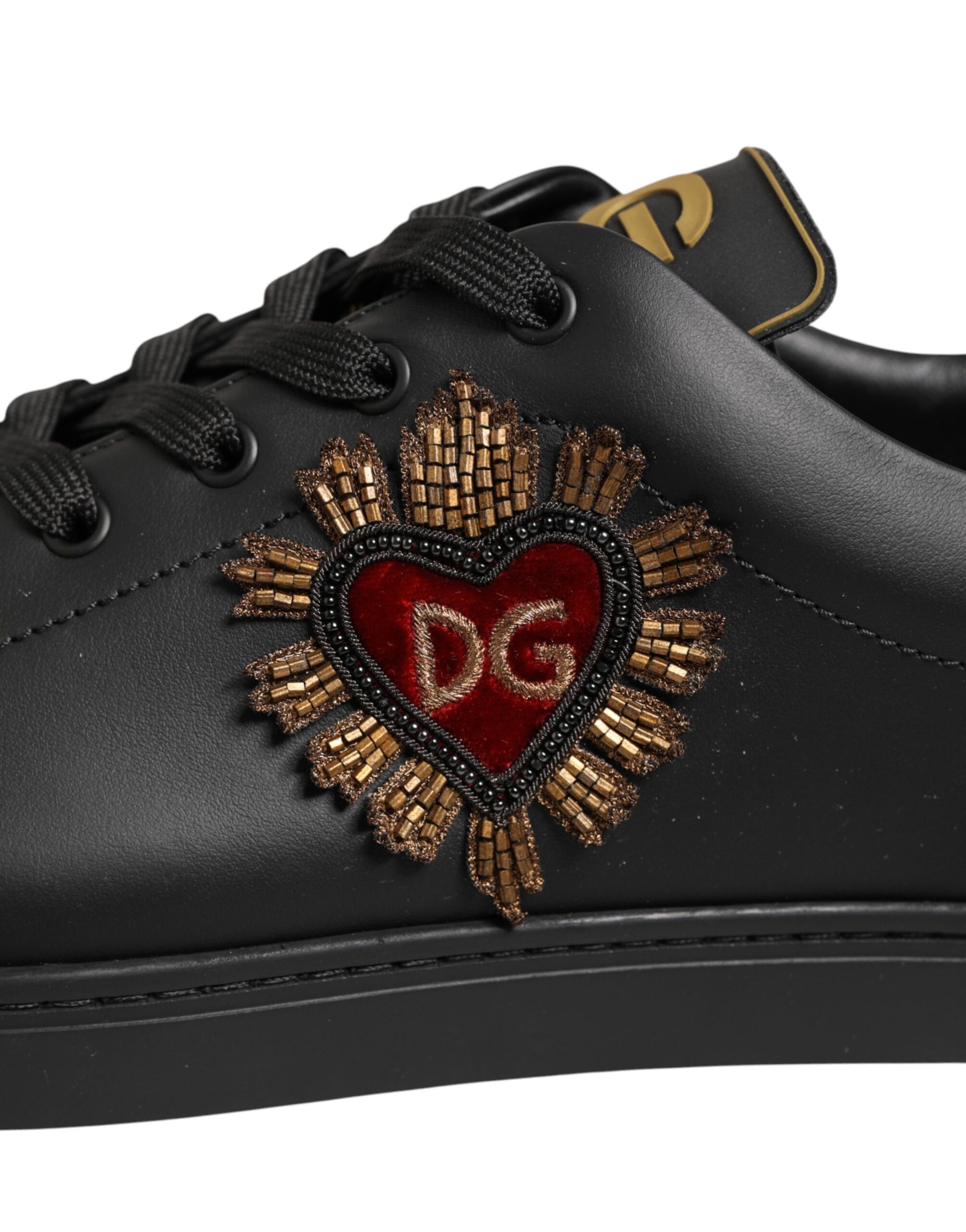 Close‑up detail of Dolce & Gabbana black leather heart embellished sneakers by KILAUE
