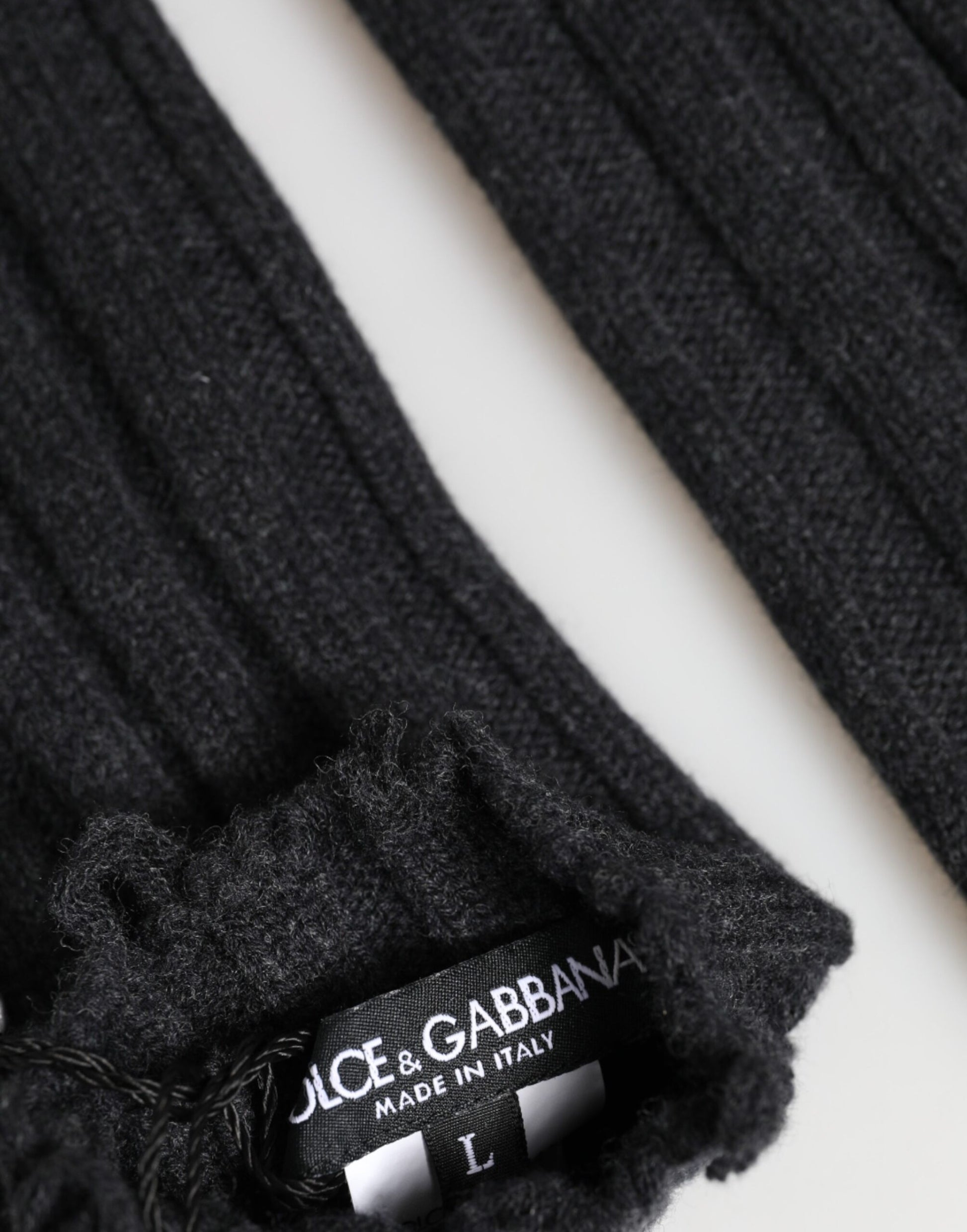 Close-up detail of Dolce & Gabbana black virgin wool fingerless gloves by KILAUE
