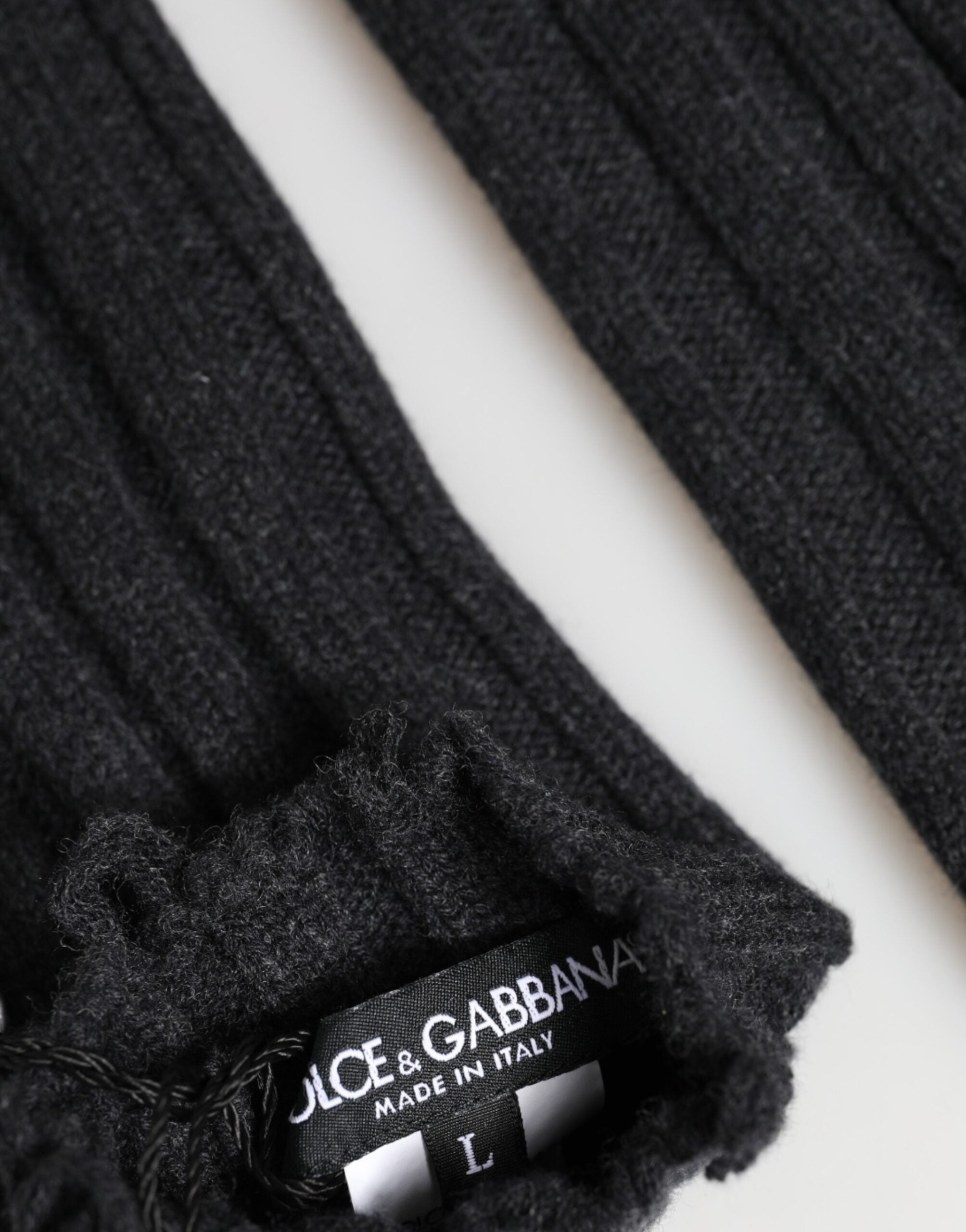 Close-up detail of Dolce & Gabbana black virgin wool fingerless gloves by KILAUE

