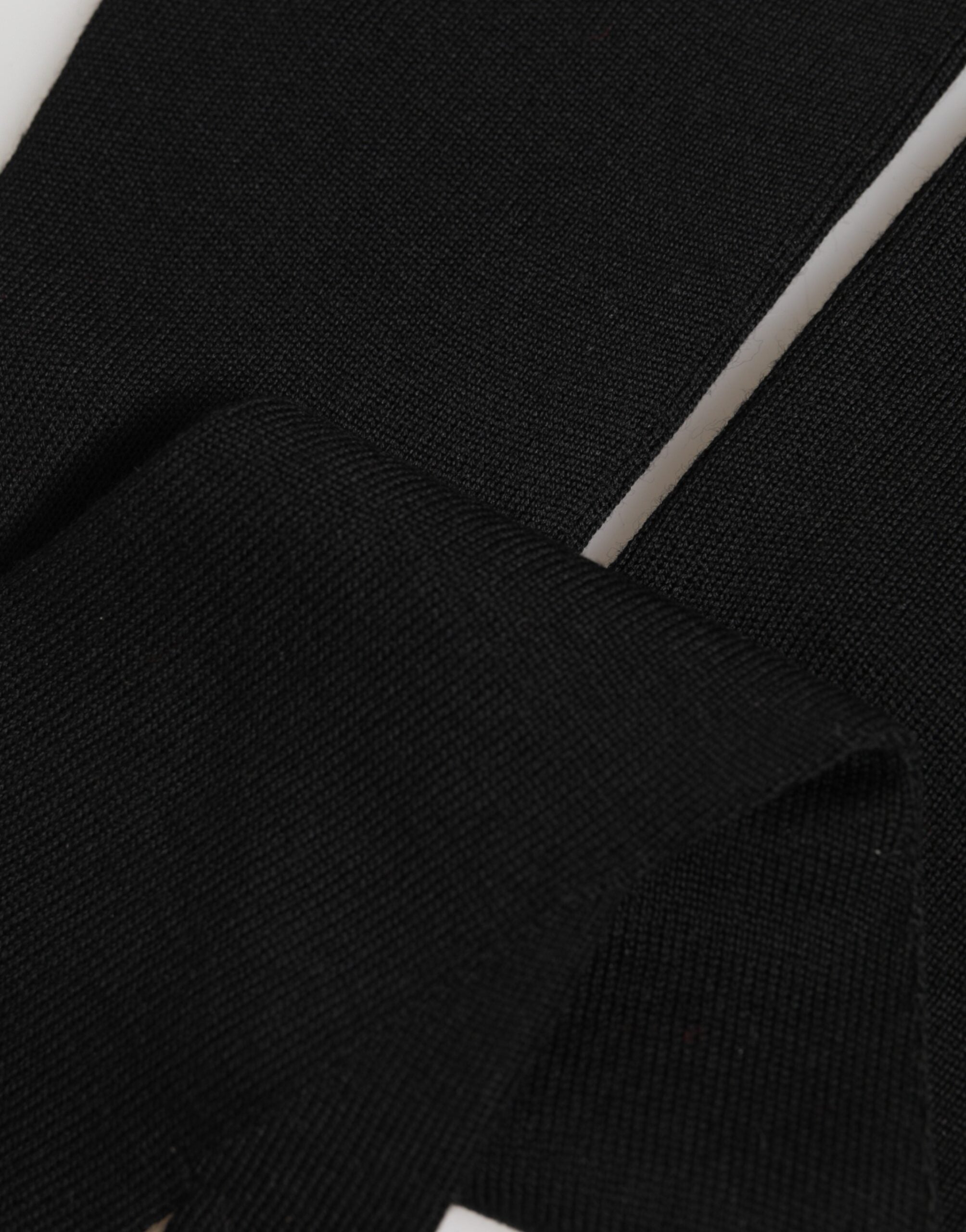 Close-up detail of Dolce & Gabbana black virgin wool fingerless gloves by KILAUE
