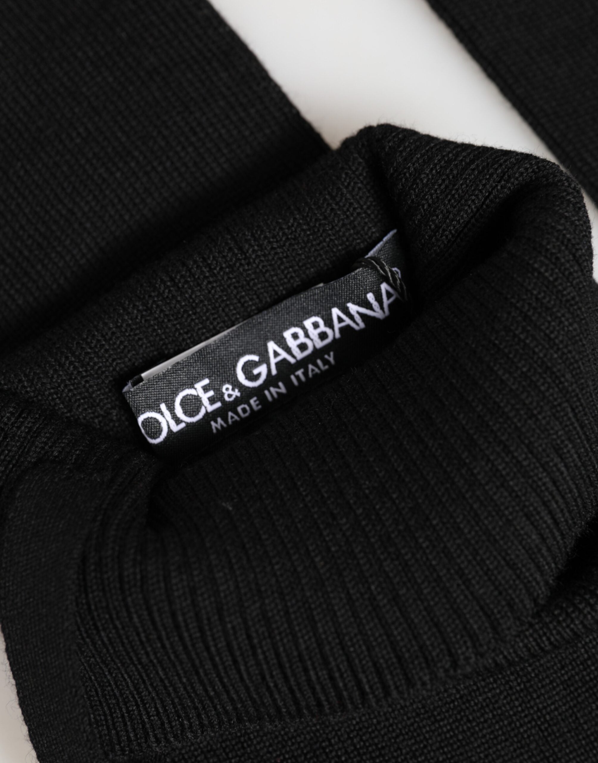 Front view of Dolce & Gabbana black virgin wool fingerless gloves by KILAUE

