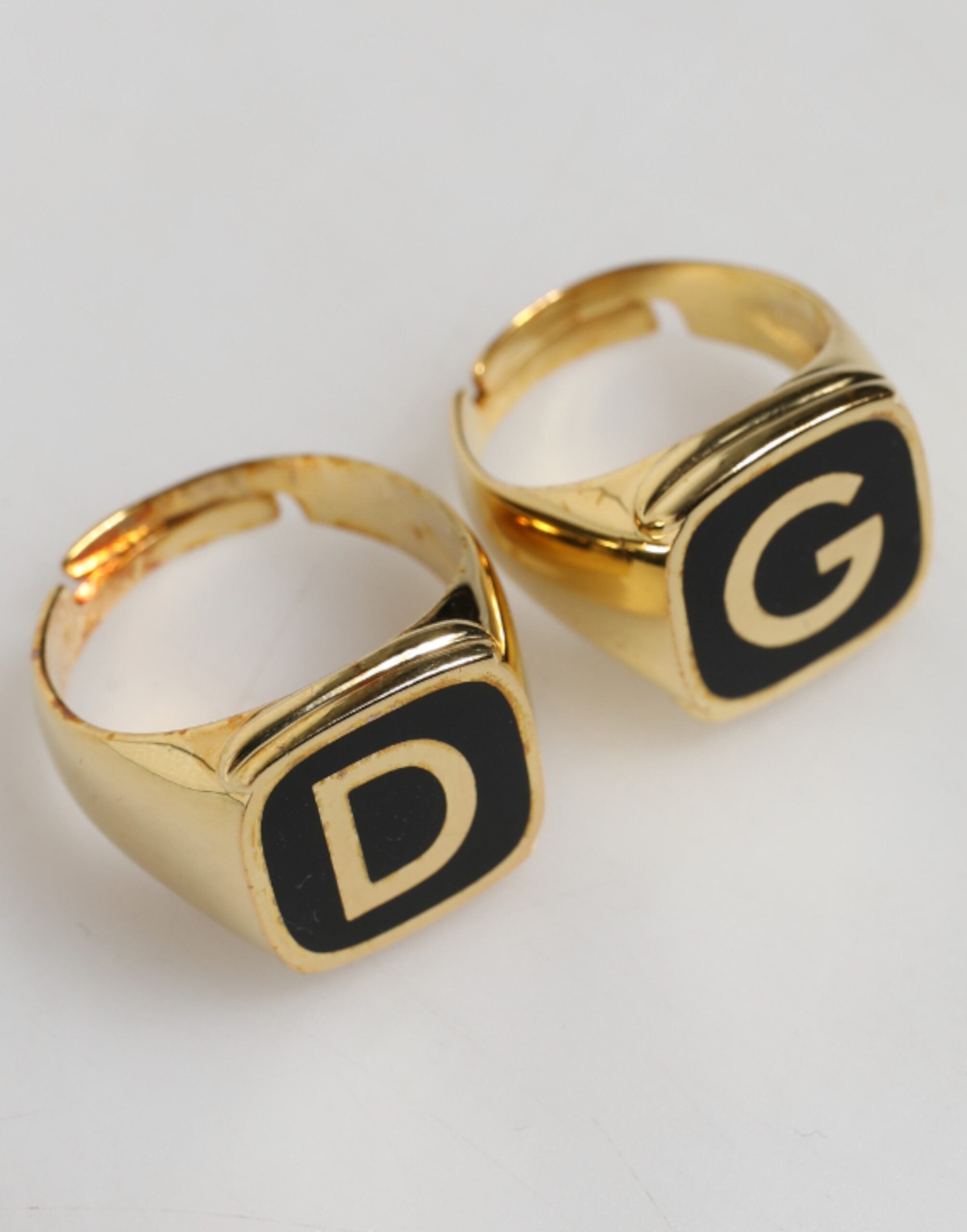 Close-up of Dolce & Gabbana gold-tone brass black enamel logo adjustable ring by KILAUE
