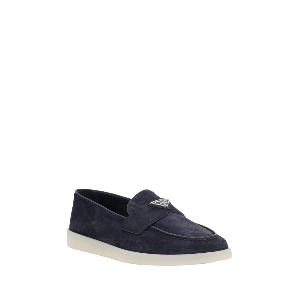 Side view of Prada blue suede slip-on loafers